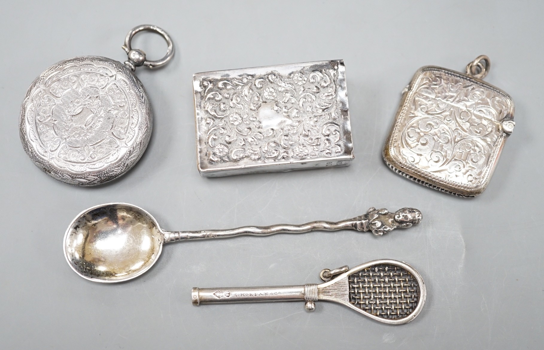 A late Victorian novelty white metal propelling pencil, modelled as a tennis racket, by Sampson Mordan & Co, 64mm, together with a watch case, silver vesta case, spoon and silver matchbox sleeve.